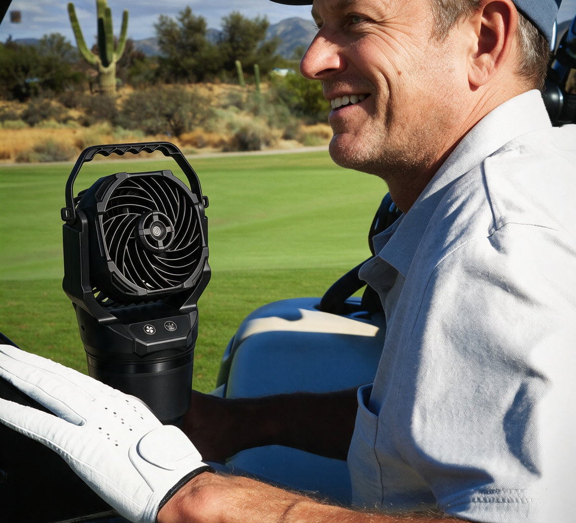 Chill Isle Breeze misting fan in a golf cart cup holder beside a smiling golfer