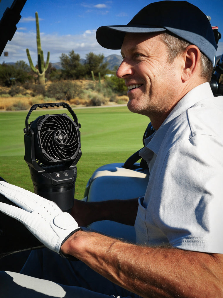 Chill Isle Breeze misting fan in a golf cart cup holder beside a smiling golfer
